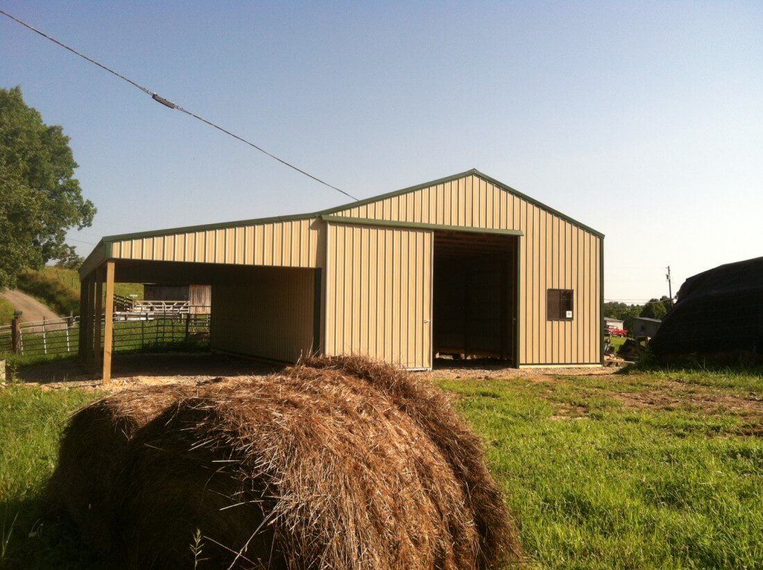 A garage built for agricultural equipment, a tractor sits inside